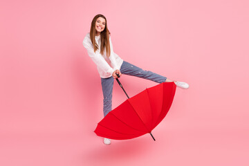 Full body photo of brown hairdo young lady with umbrella wear hoodie jeans sneakers isolated on...