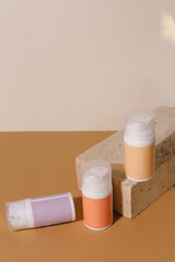 Eco friendly Bottle and tube with natural skincare cosmetics, creams or oils on light background. Plant-based beauty products