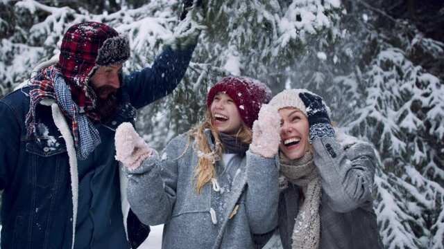 Family with small daughter having fun outdoors in winter nature, looking at camera. Tatra mountains Slovakia.