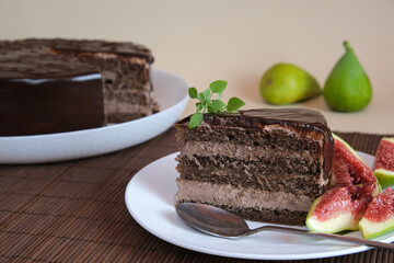 Plate with a slice of delicious homemade chocolate cake decorated with figs. Birthday cake.
