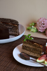 Plate with a slice of delicious homemade chocolate cake decorated with figs. Birthday cake.
