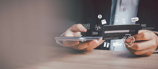 shopping online with credit card, e-commerce, spending money concept. Business man hold credit card and using smartphone with cart, discounted price, delivery, 24 hours service icon with copy space.