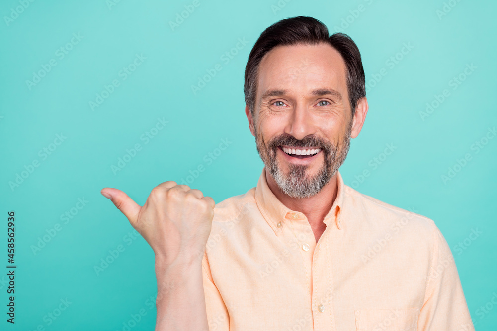 Sticker photo of optimistic age man point empty space wear peach shirt isolated on teal color background