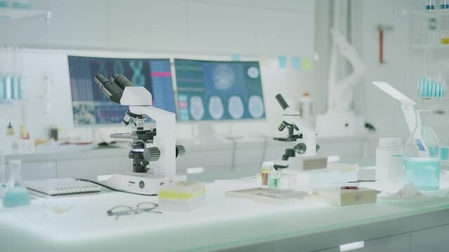 Empty laboratory interior with microscope and computers