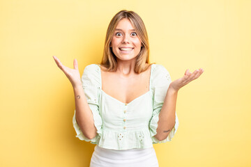 blonde pretty woman feeling happy, excited, surprised or shocked, smiling and astonished at...