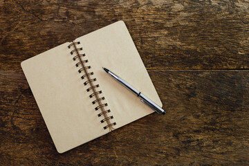 Notebook and pen on wooden background. write message diary book document education, Top view.