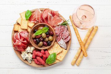 Antipasto board with prosciutto, salami, crackers, cheese, olives