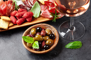 Antipasto board with prosciutto, salami, crackers, cheese, olives