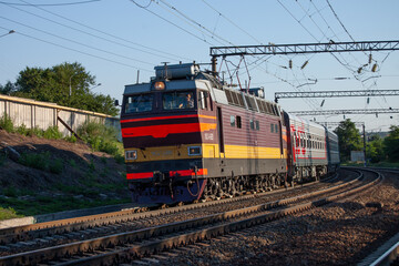 Fototapeta na wymiar A passenger train moving on the tracks near the station Rostov-Main