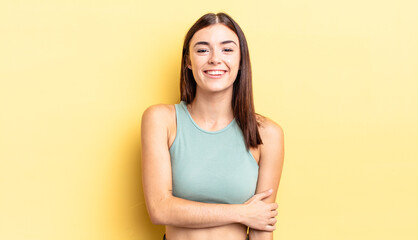 hispanic pretty woman laughing shyly and cheerfully, with a friendly and positive but insecure...