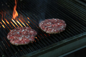 Fresh tasty burger on dark background - Hamburgers cooking on grill