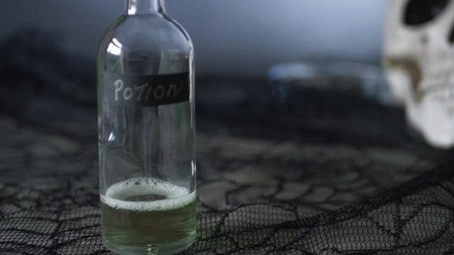 Witches potion with human skull in background 