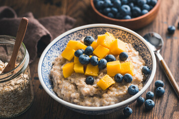 Healthy Breakfast Food Oatmeal Porridge With Fruits And Berries On Wooden Table Background, Closeup View