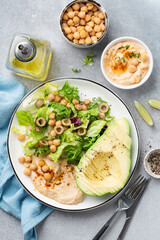 Top view healthy vegan avocado hummus salad. Clean eating, dieting concept