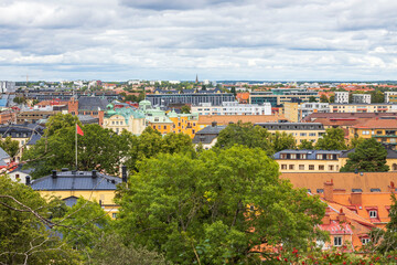 Fototapeta na wymiar Beautiful panoramic view over city landscape under blue sky with puffy white clouds. Europe. Sweden. Uppsala.
