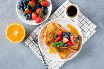 Sweet french toasts with berries and honey served with cup of espresso coffee. Top view. Breakfast...
