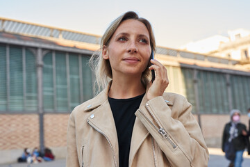 Beautiful woman making a phone-call outdoors