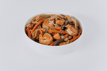 white plate of noodles with chicken