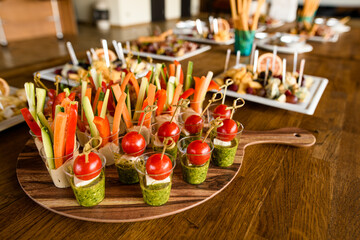 catering vegetarian banquet table with variety of vegetables and vegan snacks and vegetable...