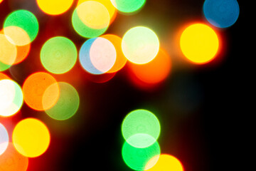 blurred defocused christmas lights bokeh on a black background
