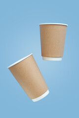 empty paper cup to go against light blue concrete background