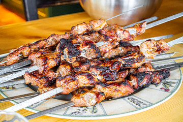 Russian shashlik with skewers on plate and wooden table Norway.