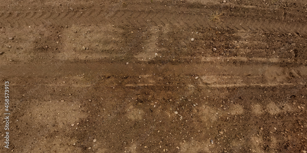 Wall mural panorama of road from above on surface of gravel road with car tire tracks