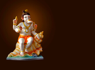 Hindu God Ganesha on colorful background, with copy space, Ganesha is the patron of arts and sciences
