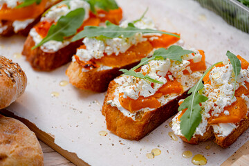 grilled ciabatta bruschetta with baked pumpkin, feta arugula and spices. healthy fall baked pumpkin snack
