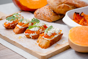 grilled ciabatta bruschetta with baked pumpkin, feta arugula and spices. healthy fall baked pumpkin snack