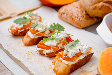 grilled ciabatta bruschetta with baked pumpkin, feta arugula and spices. healthy fall baked pumpkin snack
