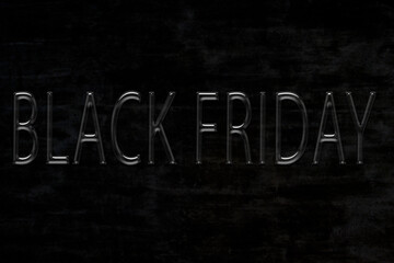 Black Friday is written on a black background in black glossy letters.