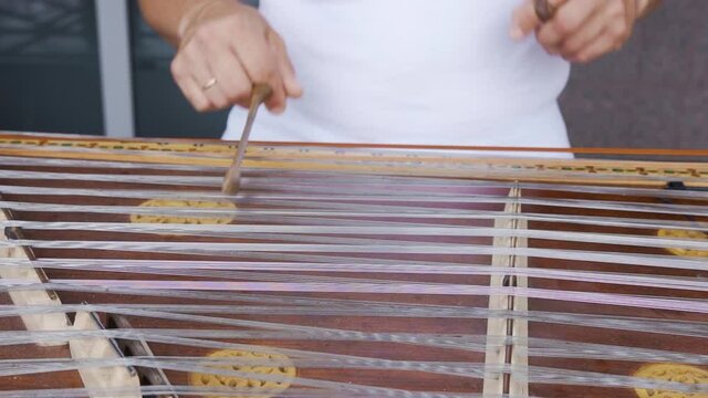 Playing stringed instrument. Hammered dulcimer close up. Leisure and hobby concept. Meditation music. Musician playing hammered dulcimer close-up. Stringed percussion musical instrument sounds good