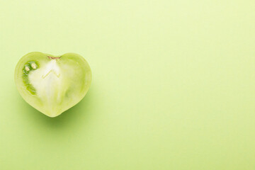 Green tomatoes for preservation on a pink background. Unripe tomatoes for harvesting. Cutaway...