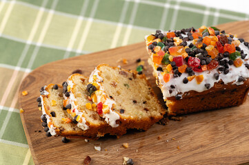 italian christmas cupcake sliced on wooden board, checkered tablecloth and white background