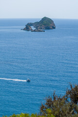 Fototapeta na wymiar A sea view of a speedboat and a distant island