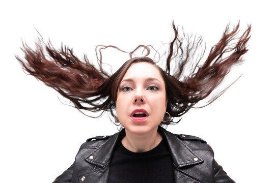 Portrait of woman in black biker jacket with tossed up hair and open mouth, heavy metal style, isolated on white background