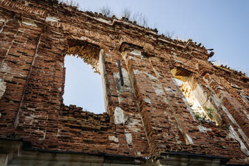 Old destroyed church. Old red brick wall with a destroyed window opening