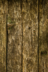 Vintage brown wood background texture with knots and nail holes. Old painted wood wall.