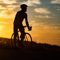 Fototapeta na wymiar cyclist silhouette at sunset sports and fitness concept