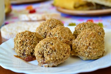 Plate with meatballs on a table with more food