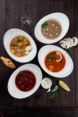 Assortment of soups in a restaurant menu: mushroom cream soup, peasants' soup, borsch and chicken soup