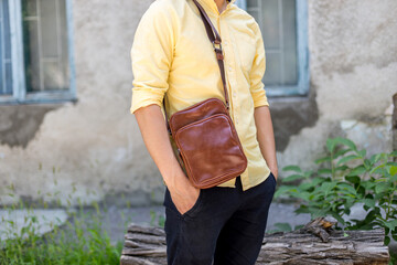 Woman with brown leather handbags in the hand