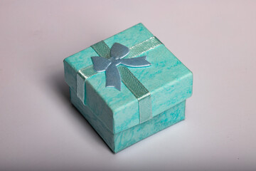 Turquoise gift box with bow on white background