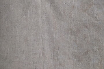 Coarse linen fabric. Old linen fabric. Coarse burlap. Background of rough natural fabric.