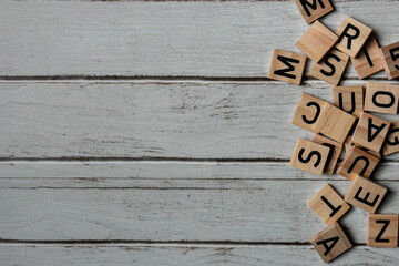 Wooden background with scattered letters