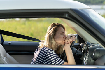 Anxious woman in car. Female driver thoughtful looking on road suffering from anxiety or headache...