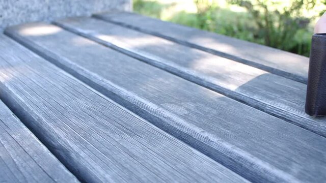 The lost wallet on the park bench is taken by the child's hand. Lost item on the street