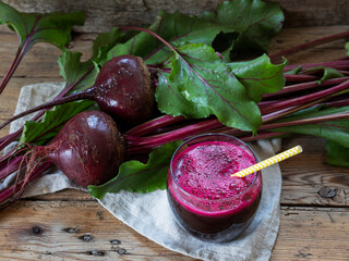 Fresh squeezed  beetroot juice in a glass on a wooden surface  Healthy eating, detox, dieting and vegetarian concept.