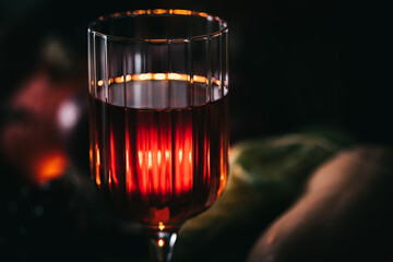 Glass of rose wine or cider in wine glass in a moody autumn vintage atmosphere